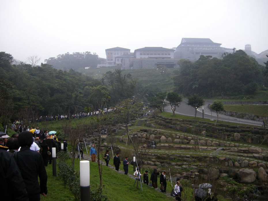 Mourners processing down from the burial area