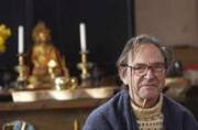 John Crook sitting in front of the altar at Maenllwyd